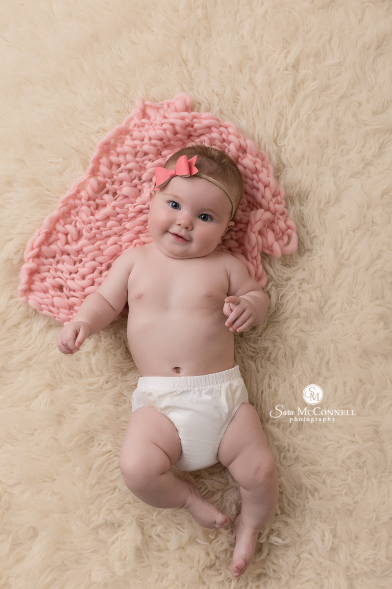 Ottawa newborn photos by Sara McConnell Photography - Baby with a pink bow in her hair