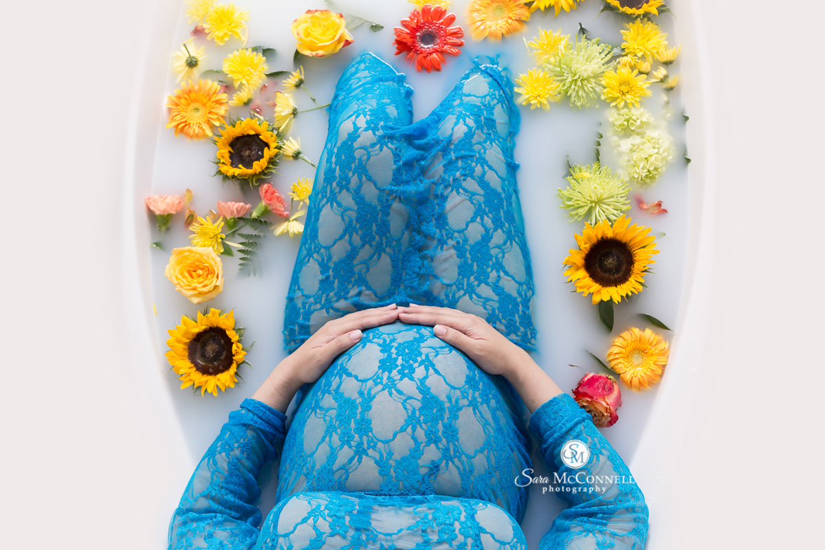 Milk Bath Photos by Sara McConnell Photography - Expectant Mother in bath of milk with flowers