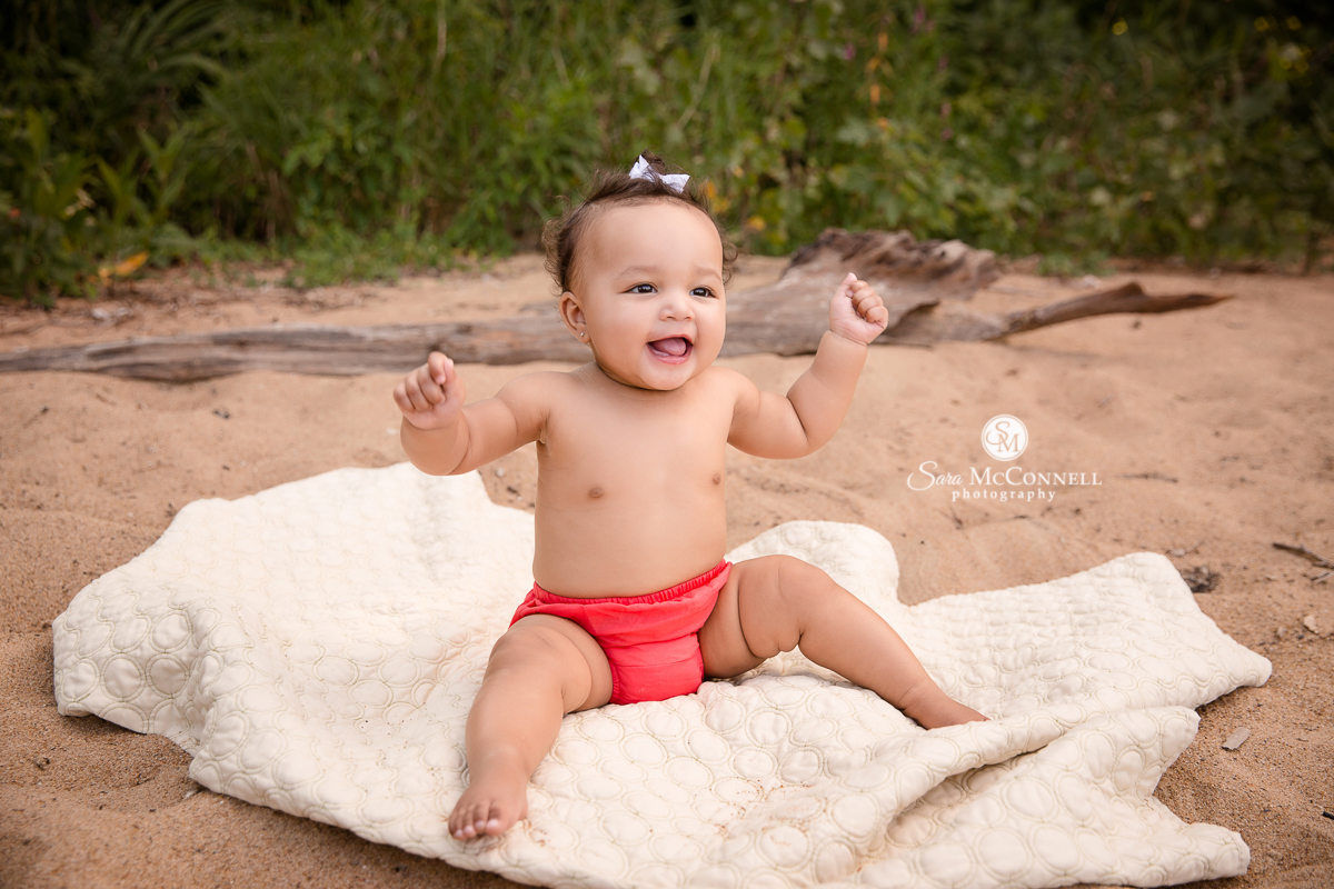 Baby smiling and laughing on the beach