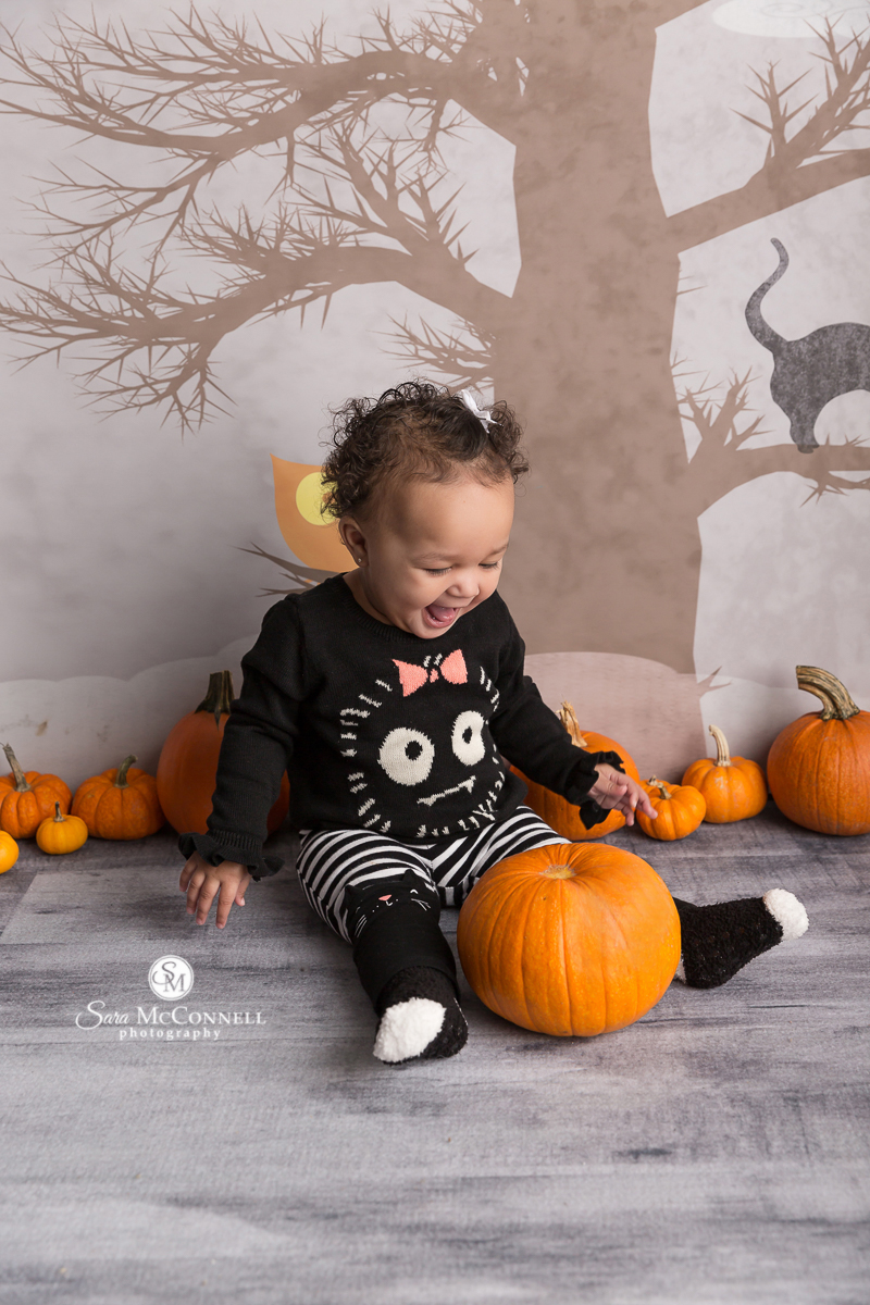 Baby smiling for a Halloween photo