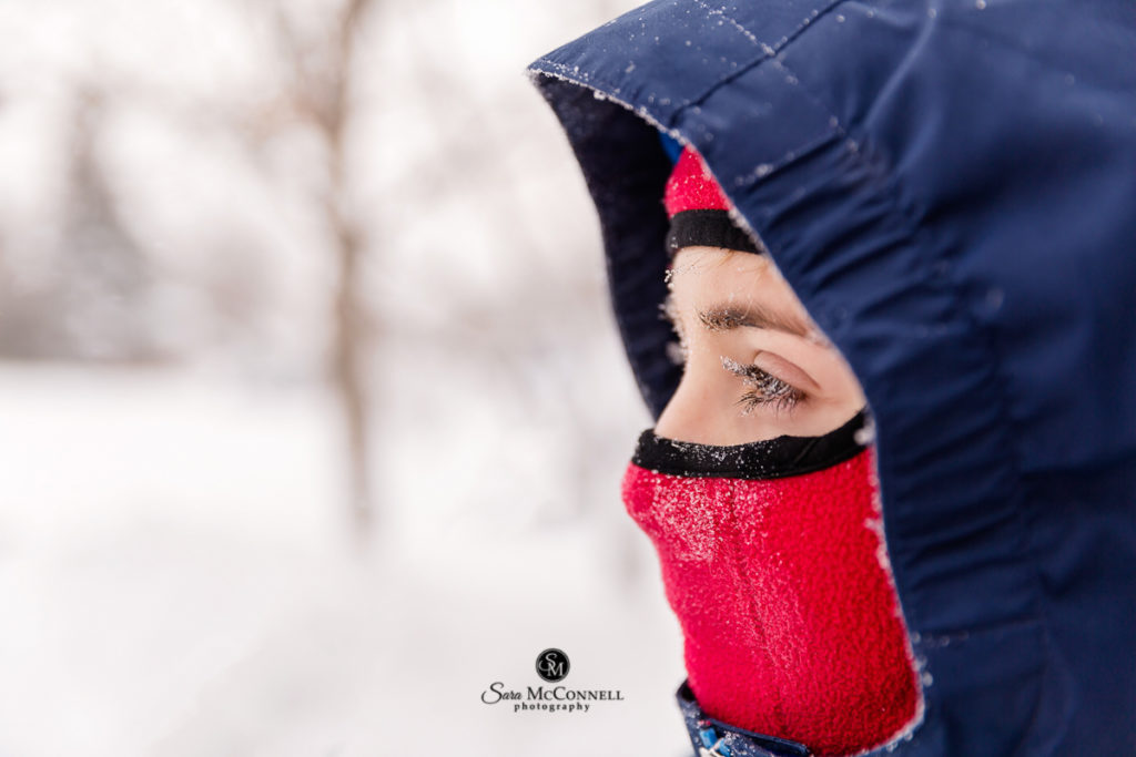 teen boy wearing winter gear on a snowy day