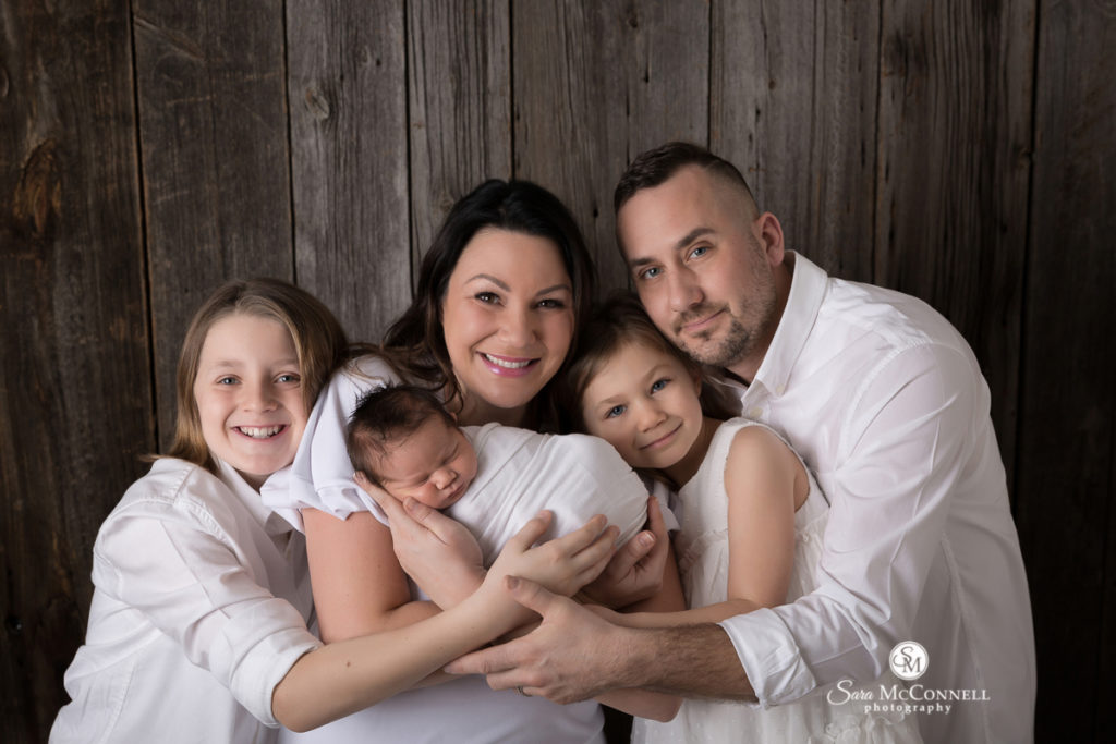 family of five with newborn baby
