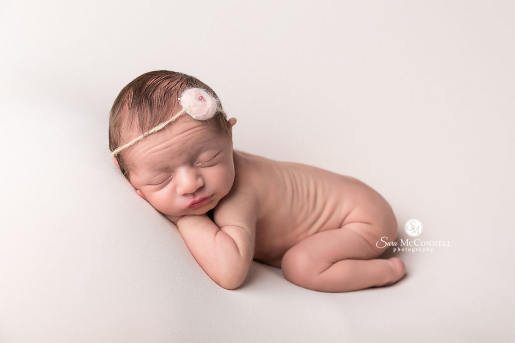 sleeping newborn baby wearing a headband