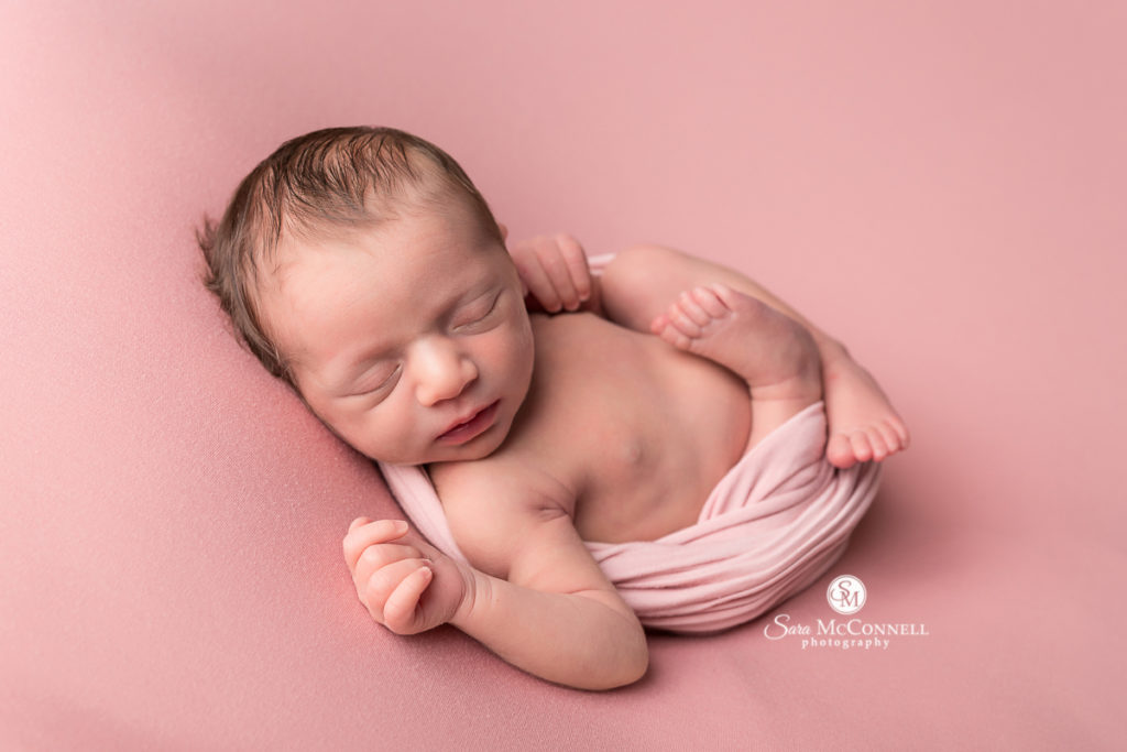 newborn baby wearing pink