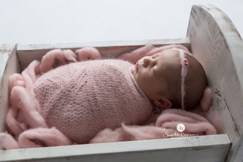 newborn baby wrapped in pink