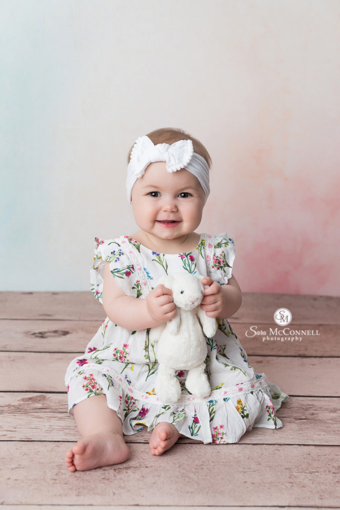 8 month old baby holding a stuffed bunny