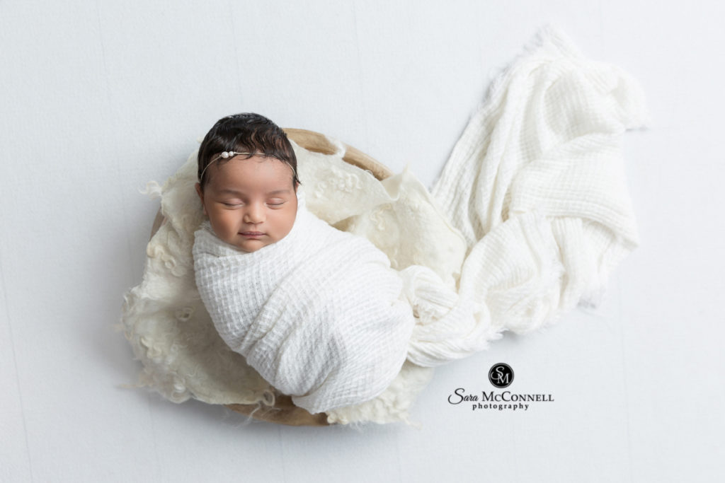 newborn baby wrapped in a white blanket