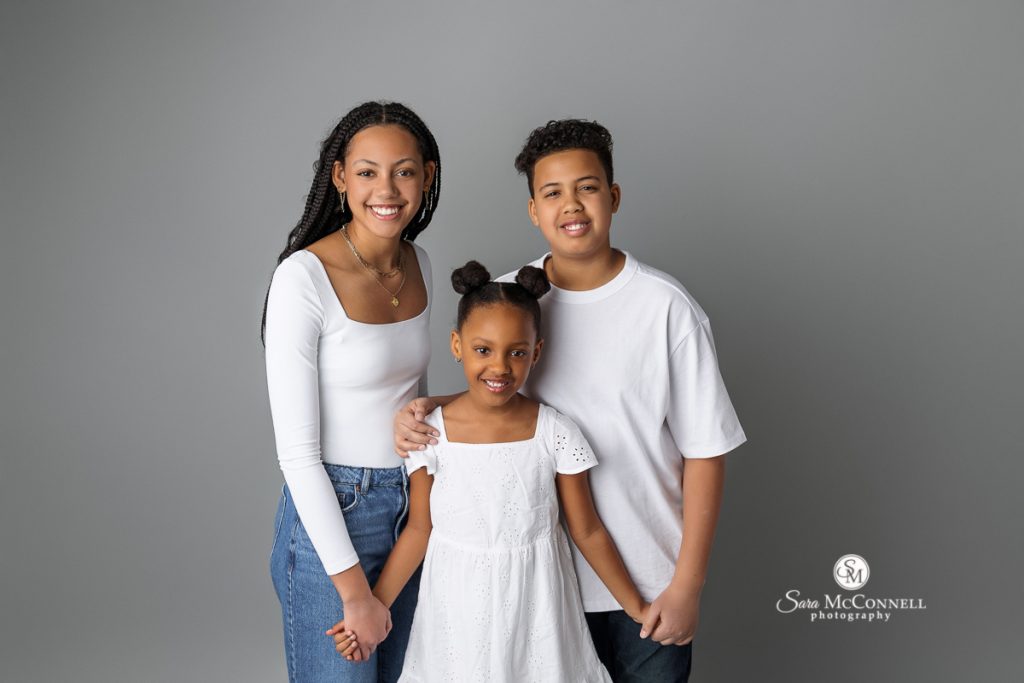 Photo of smiling siblings in a Family Photography Sessions in Studio blog post by family photographer ottawa