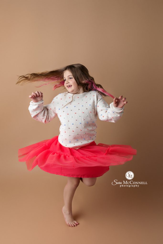 Photo of girl twirling in a blog post about Candid versus posed images. Ottawa maternity photographers.