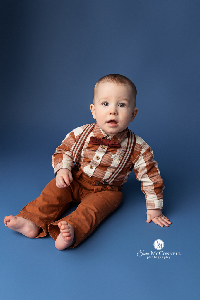 A photo of a 1 year old boy in a blog post about Ottawa First Birthday Photo Session Ideas. Maternity and newborn photography.